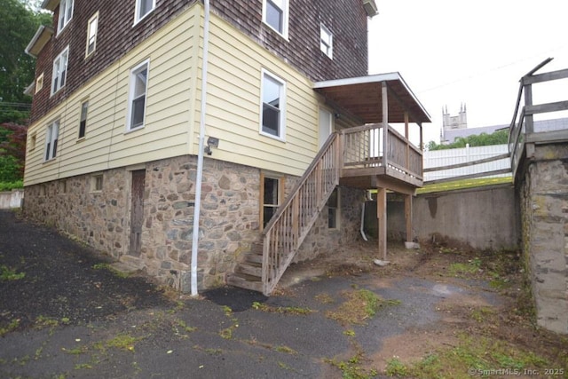 484 W St, Bristol, CT 06010 - rear view of property with stairway and a wooden deck