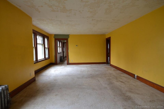 484 W St, Bristol, CT 06010 - carpeted empty room with radiator and baseboards