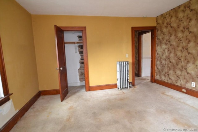 484 W St, Bristol, CT 06010 - unfurnished bedroom featuring carpet flooring, radiator, and wallpapered walls