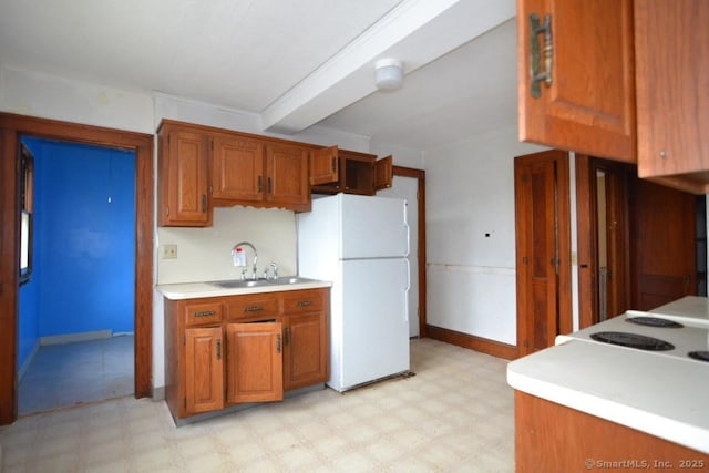 484 W St, Bristol, CT 06010 - kitchen featuring freestanding refrigerator, light floors, brown cabinetry, and light countertops