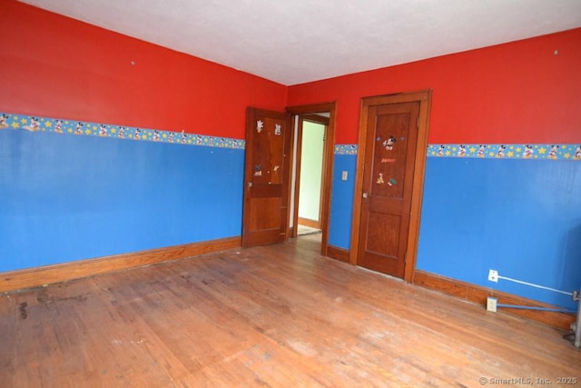 484 W St, Bristol, CT 06010 - spare room featuring wood finished floors and baseboards