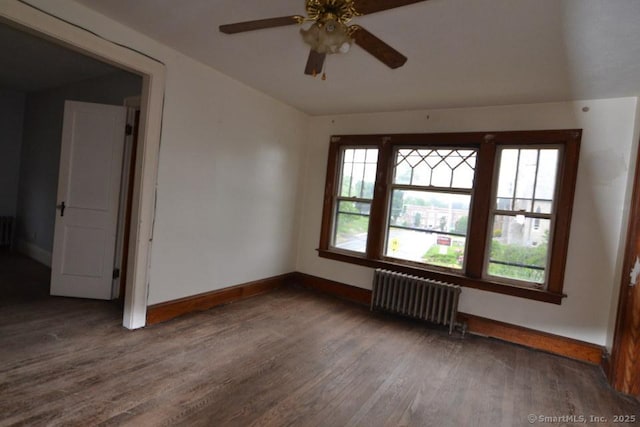 484 W St, Bristol, CT 06010 - empty room with radiator, wood finished floors, plenty of natural light, a ceiling fan, and vaulted ceiling