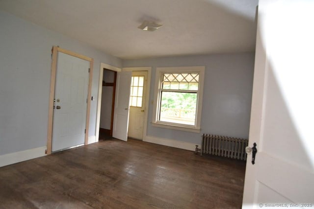 484 W St, Bristol, CT 06010 - entrance foyer featuring radiator heating unit and wood finished floors