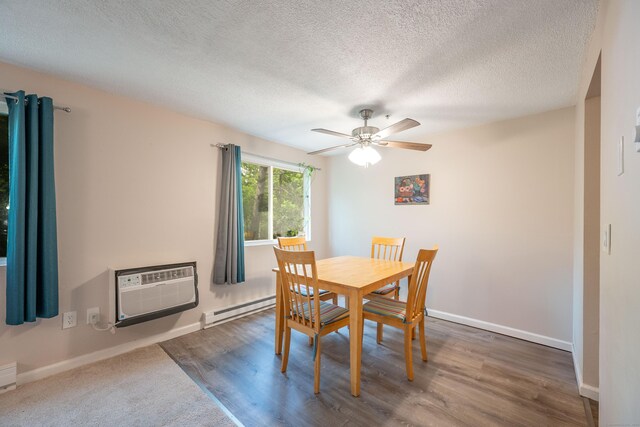 14 Newtown Rd Unit B9, Danbury, CT 06810 - dining area with a baseboard radiator, a ceiling fan, a textured ceiling, wood finished floors, and an AC wall unit