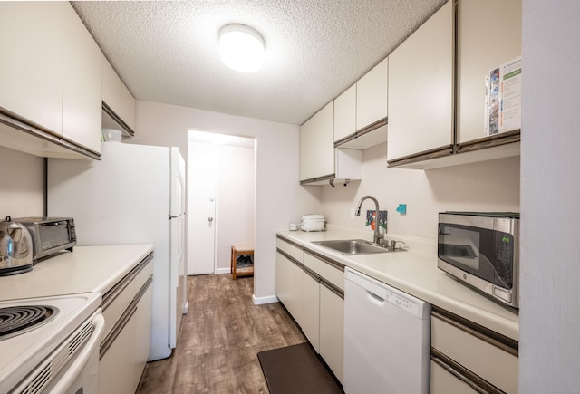 14 Newtown Rd Unit B9, Danbury, CT 06810 - kitchen featuring white appliances, wood finished floors, light countertops, white cabinetry, and a textured ceiling