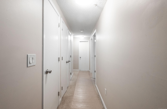 14 Newtown Rd Unit B9, Danbury, CT 06810 - hallway with a textured ceiling and baseboards
