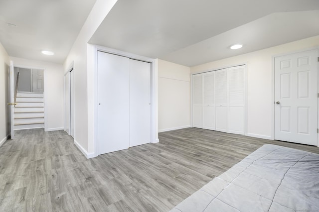 51 Old Kings Hwy Unit 5, Greenwich, CT 06897 - unfurnished bedroom featuring wood finished floors, two closets, and recessed lighting