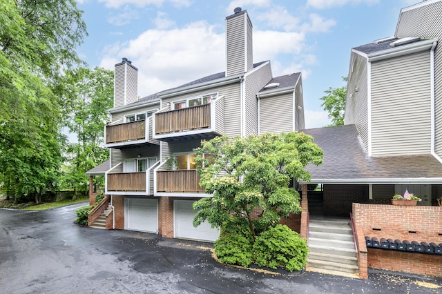 51 Old Kings Hwy Unit 5, Greenwich, CT 06897 - view of building exterior featuring a garage, driveway, and stairs