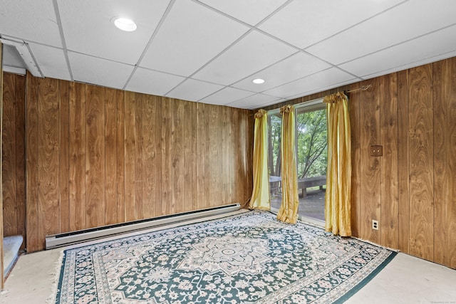 46 Rising Trail Dr Unit 46, Middletown, CT 06457 - empty room featuring a baseboard radiator, wooden walls, a drop ceiling, and concrete floors