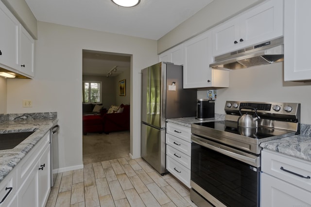 94 The Laurels Unit 94, Enfield, CT 06082 - kitchen with appliances with stainless steel finishes, under cabinet range hood, light wood-style flooring, white cabinetry, and light stone countertops
