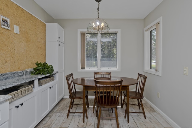 94 The Laurels Unit 94, Enfield, CT 06082 - dining area with plenty of natural light, a chandelier, and light wood-style floors