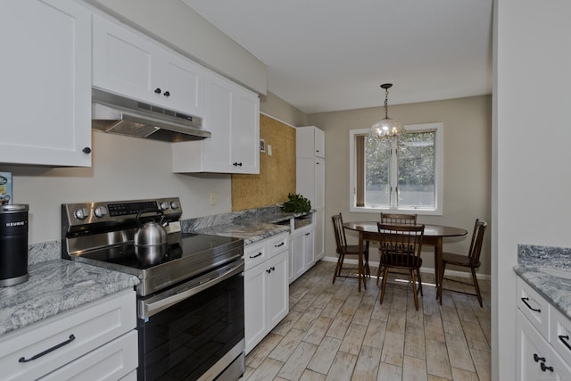 94 The Laurels Unit 94, Enfield, CT 06082 - kitchen with stainless steel electric stove, under cabinet range hood, white cabinetry, pendant lighting, and light wood-style floors