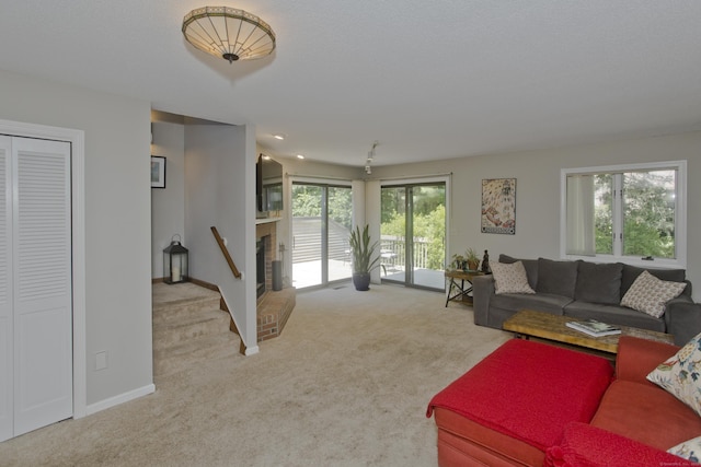 94 The Laurels Unit 94, Enfield, CT 06082 - living area with carpet and a brick fireplace