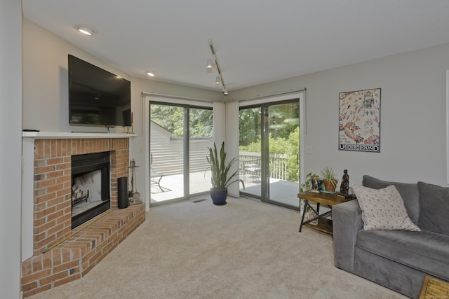 94 The Laurels Unit 94, Enfield, CT 06082 - carpeted living room with a brick fireplace and track lighting