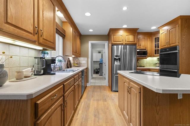 72 Hazelwood Dr, Southington, CT 06489 - kitchen featuring stainless steel appliances, recessed lighting, brown cabinets, tasteful backsplash, and light wood finished floors