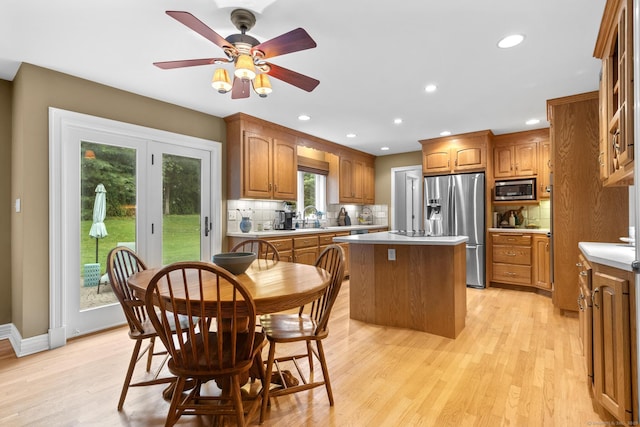 72 Hazelwood Dr, Southington, CT 06489 - kitchen featuring appliances with stainless steel finishes, a kitchen island, brown cabinets, backsplash, and recessed lighting