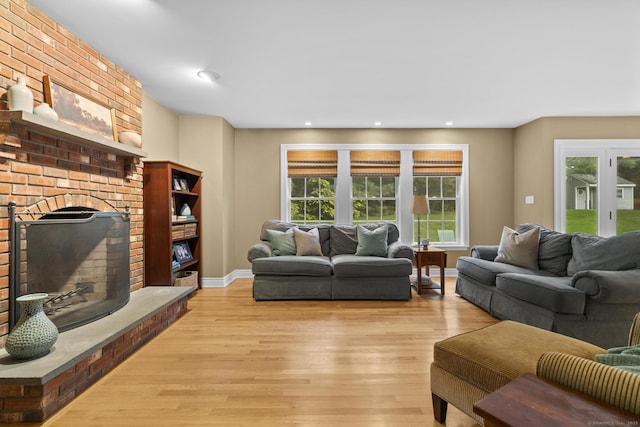 72 Hazelwood Dr, Southington, CT 06489 - living room with light wood-style flooring, a brick fireplace, and recessed lighting