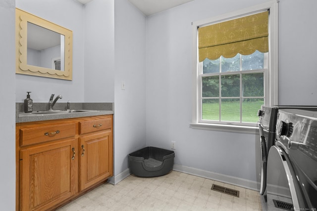 72 Hazelwood Dr, Southington, CT 06489 - laundry area featuring washing machine and dryer, light flooring, and cabinet space