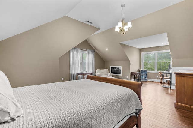 72 Hazelwood Dr, Southington, CT 06489 - bedroom with vaulted ceiling, wood finished floors, and a chandelier