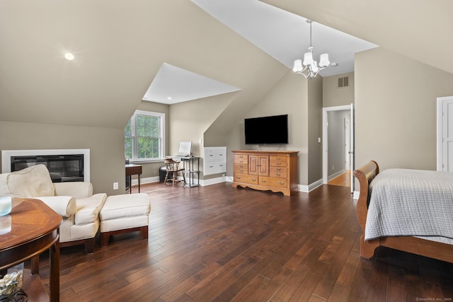 72 Hazelwood Dr, Southington, CT 06489 - bedroom featuring lofted ceiling, a chandelier, dark wood finished floors, and a glass covered fireplace