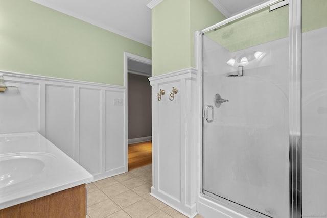 72 Hazelwood Dr, Southington, CT 06489 - bathroom with a stall shower, crown molding, tile patterned flooring, double vanity, and a decorative wall