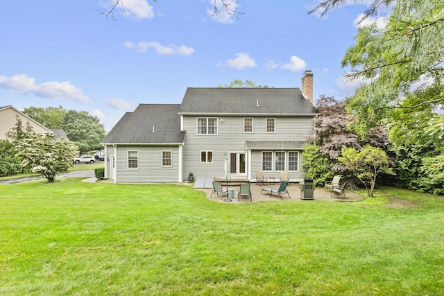 72 Hazelwood Dr, Southington, CT 06489 - back of house featuring a patio, a yard, a chimney, and a shingled roof