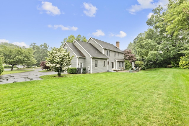 72 Hazelwood Dr, Southington, CT 06489 - back of property with a lawn, a chimney, and roof with shingles