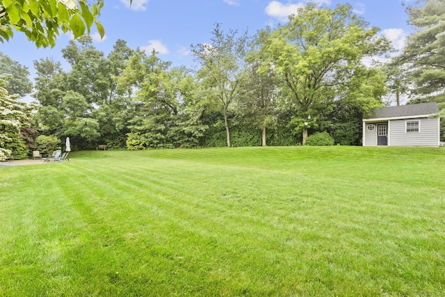 72 Hazelwood Dr, Southington, CT 06489 - view of green lawn with an outbuilding and view of wooded area