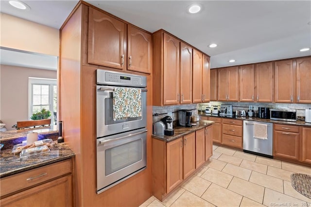 23 Sunset Hill Rd, Brookfield, CT 06804 - kitchen featuring appliances with stainless steel finishes, tasteful backsplash, dark stone countertops, recessed lighting, and light tile patterned floors