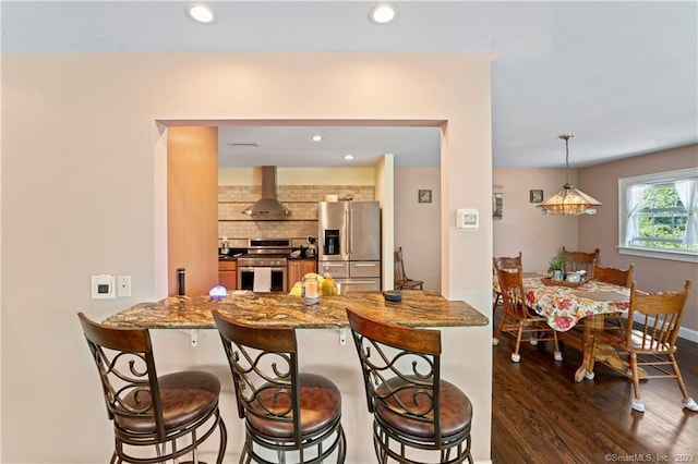 23 Sunset Hill Rd, Brookfield, CT 06804 - kitchen with appliances with stainless steel finishes, ventilation hood, a kitchen bar, decorative backsplash, and recessed lighting
