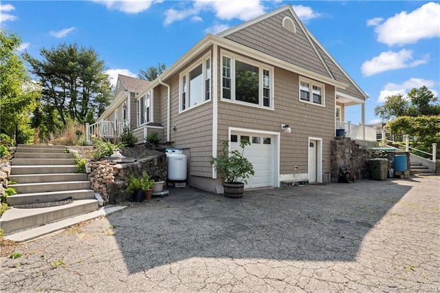 23 Sunset Hill Rd, Brookfield, CT 06804 - view of side of home with stairs, a garage, and driveway