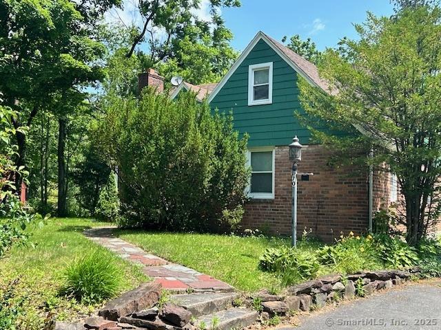 70 Tunxis Ave, Bloomfield, CT 06002 - view of side of home featuring brick siding and a chimney