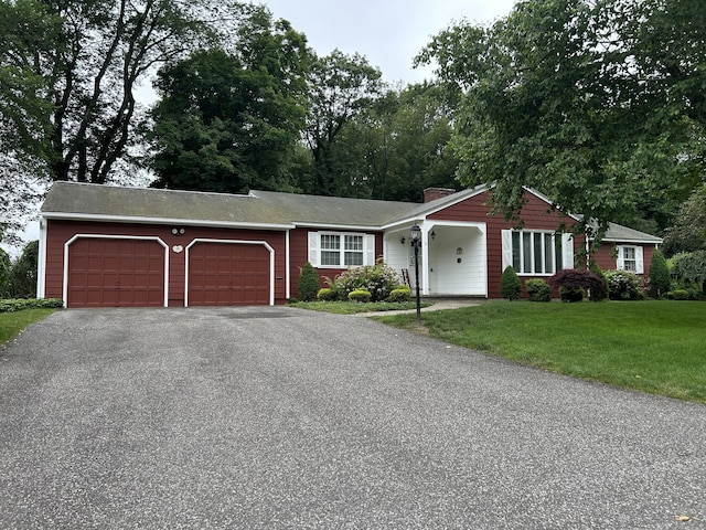 16 Round Hill Cir, Naugatuck, CT 06770 - ranch-style home with an attached garage, driveway, a front lawn, and a chimney