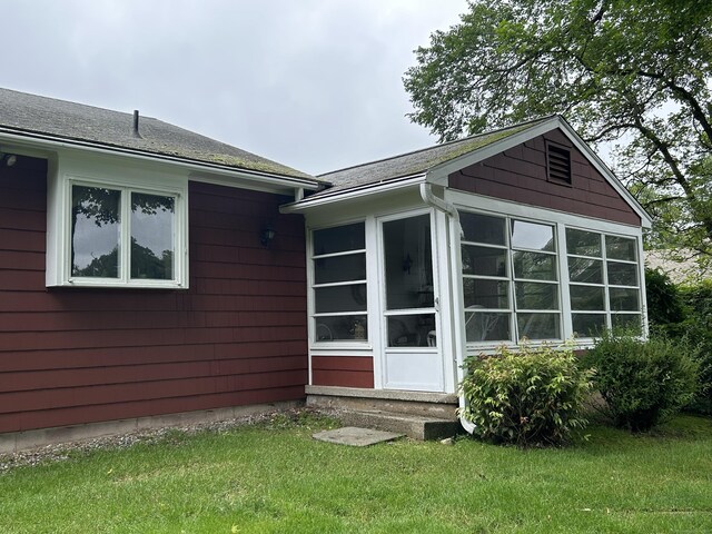 16 Round Hill Cir, Naugatuck, CT 06770 - view of side of home with a sunroom, a lawn, and roof with shingles
