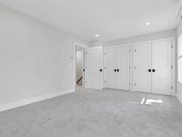 138 Boston Post Rd Unit 15, East Lyme, CT 06333 - unfurnished bedroom featuring two closets, carpet flooring, and recessed lighting