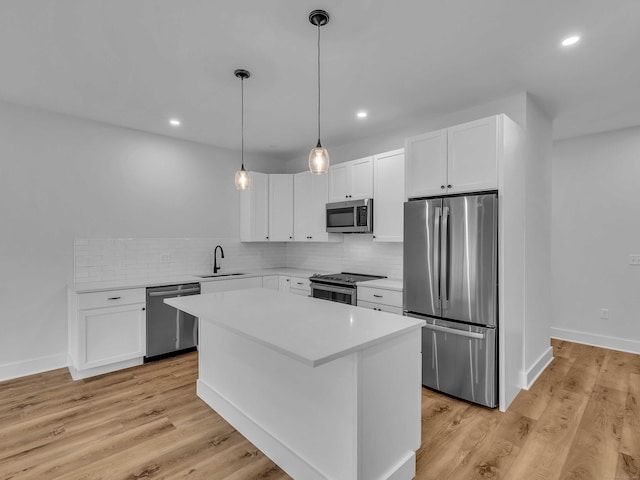 138 Boston Post Rd Unit 15, East Lyme, CT 06333 - kitchen featuring stainless steel appliances, light countertops, backsplash, white cabinetry, and recessed lighting