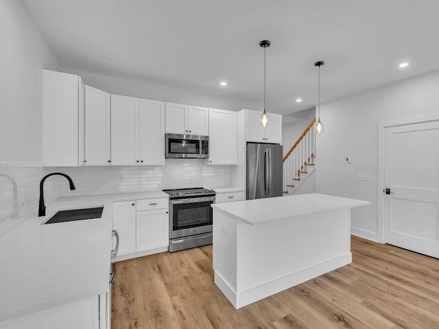 138 Boston Post Rd Unit 15, East Lyme, CT 06333 - kitchen featuring appliances with stainless steel finishes, light countertops, decorative backsplash, light wood-type flooring, and recessed lighting
