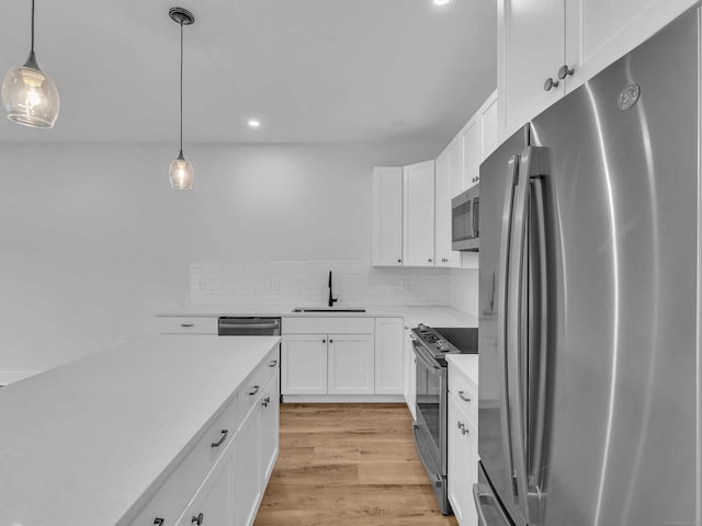 138 Boston Post Rd Unit 15, East Lyme, CT 06333 - kitchen featuring appliances with stainless steel finishes, light countertops, white cabinetry, light wood-type flooring, and recessed lighting