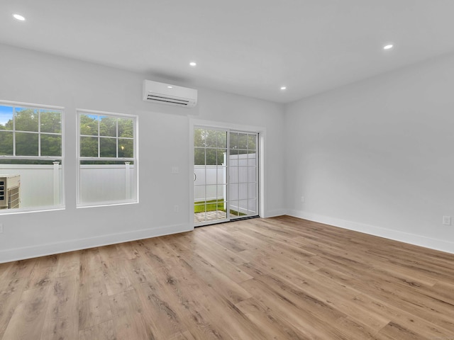 138 Boston Post Rd Unit 15, East Lyme, CT 06333 - spare room featuring an AC wall unit, recessed lighting, and wood finished floors