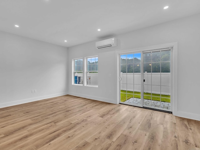 138 Boston Post Rd Unit 15, East Lyme, CT 06333 - unfurnished room with a wall mounted AC, recessed lighting, and wood finished floors