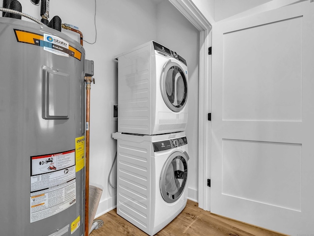 138 Boston Post Rd Unit 15, East Lyme, CT 06333 - laundry room featuring stacked washer and clothes dryer, water heater, and wood finished floors
