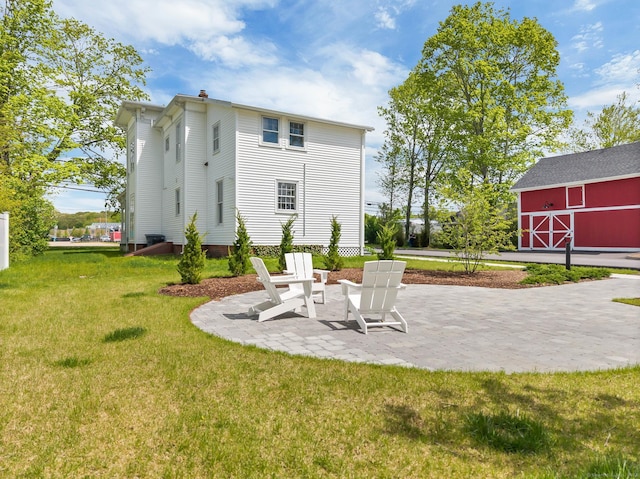 138 Boston Post Rd Unit 15, East Lyme, CT 06333 - back of property with a lawn, a barn, an outbuilding, and a patio area