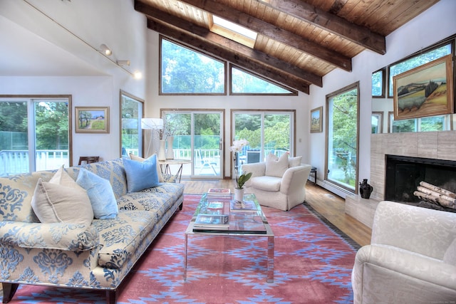 174 Cross Hwy, Westport, CT 06880 - living room with a wood ceiling with exposed beams, plenty of natural light, wood finished floors, a fireplace, and a baseboard radiator
