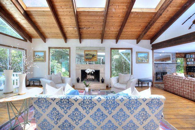 174 Cross Hwy, Westport, CT 06880 - living area with a stone fireplace, a skylight, wood finished floors, a wooden ceiling with exposed beams, and plenty of natural light