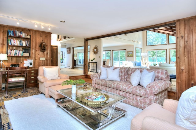 174 Cross Hwy, Westport, CT 06880 - living room featuring track lighting, wood walls, and baseboard heating
