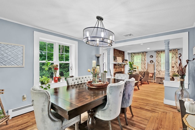 79 Ledgewood Dr, North Branford, CT 06471 - dining space with a chandelier, a baseboard radiator, crown molding, and healthy amount of natural light