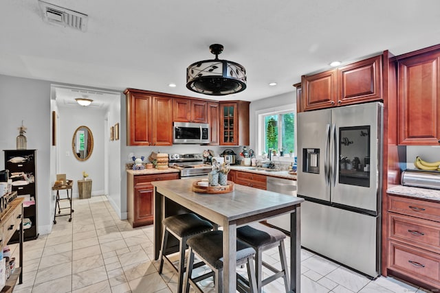 79 Ledgewood Dr, North Branford, CT 06471 - kitchen with appliances with stainless steel finishes, light marble finish flooring, recessed lighting, glass insert cabinets, and light stone counters