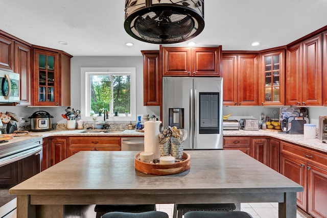 79 Ledgewood Dr, North Branford, CT 06471 - kitchen featuring appliances with stainless steel finishes, glass insert cabinets, recessed lighting, and a kitchen bar