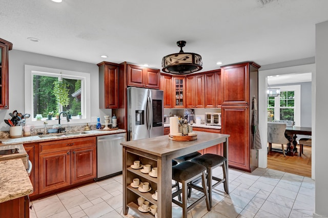 79 Ledgewood Dr, North Branford, CT 06471 - kitchen featuring stainless steel appliances, light marble finish floors, plenty of natural light, recessed lighting, and glass insert cabinets