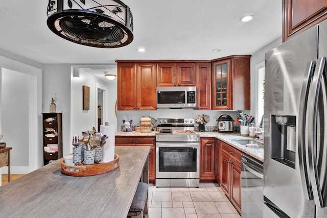 79 Ledgewood Dr, North Branford, CT 06471 - kitchen with appliances with stainless steel finishes, light marble finish floors, glass insert cabinets, and recessed lighting